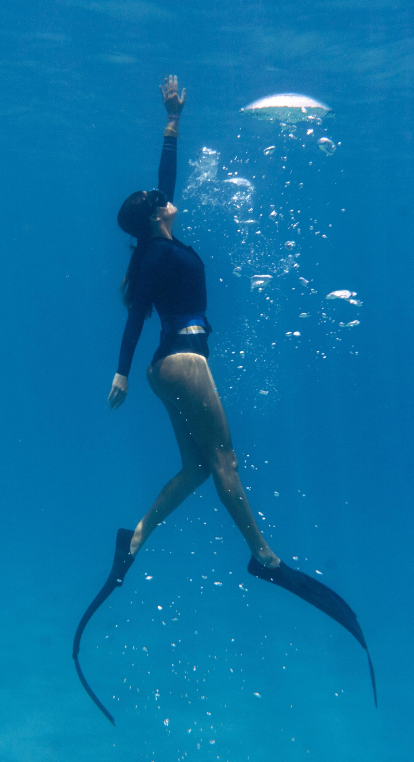 woman-freediving-with-flippers-underwater-min